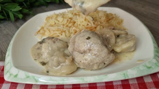 Serving Traditional Pasha and His Soldiers Dish - Kibbeh and Shish Barak in Yogurt Sauce