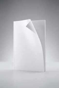 Blank white booklet mockup standing upright with a curled front page