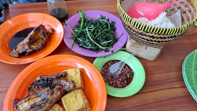 Traditional sundanese cuisine, rice tempe tofu chicken sambal and vegetables