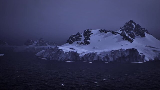 Low light snowcapped island framed by overcast sky, distant research vessel approaching coastline, icy cliffs and calm dark sea, sonar and mapping mission