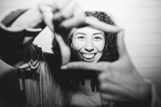 Happy african american woman having fun at night time taking photos - Party, nightlife and people lifestyle concept - UGC flash content - Main focus on nose - Black and white film camera editing