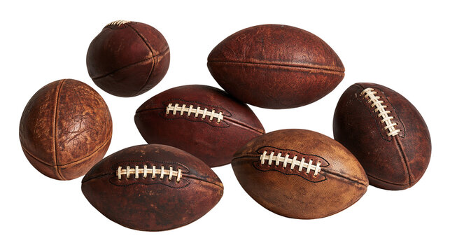Group of weathered vintage brown leather American footballs with white laces