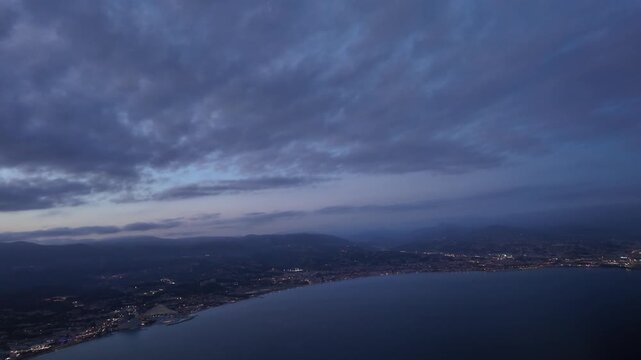 Immersive cockpit view in a real time night approach to Nice airport with a twilight sky, and a view of the runway lights. Scene taken from a jet cockpit aligning with the runway 04