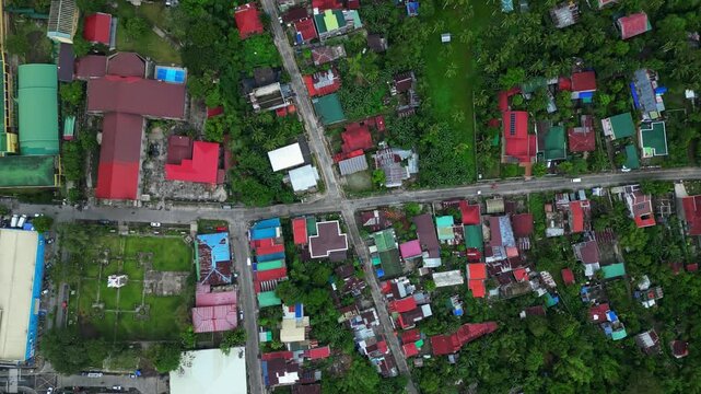 Aerial view of central Goa, Camarines Sur, featuring St. John the Baptist Parish Church, 101 Shopping Center and surrounding townscape. The footage shows the historic parish area, commercial buildings