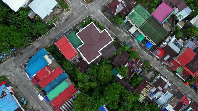 Aerial view of central Goa, Camarines Sur, featuring St. John the Baptist Parish Church, 101 Shopping Center and surrounding townscape. The footage shows the historic parish area, commercial buildings