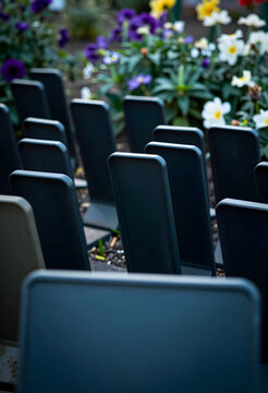 Memorial and remembrance concept, rows of empty grave markers in a peaceful cemetery garden with colorful flowers for funeral and mourning tribute