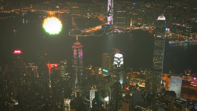 Spectacular vibrant fireworks exploding over the Hong Kong skyline at night.