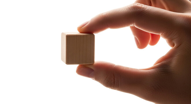 Minimalist wooden cube held by hand against neutral background for creative branding and design projects
