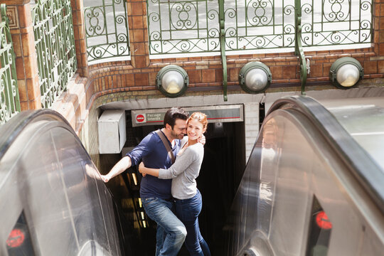 France, Paris, portrait of couple standing on escalator