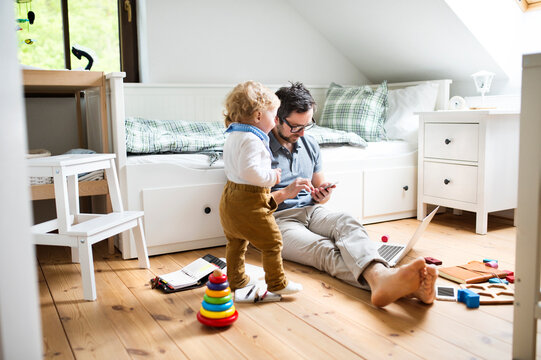 Father with his little son working from home