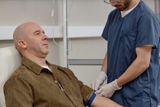Patient receiving IV therapy from doctor in clinic setting
