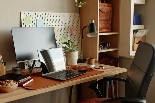 Modern home office workplace features a laptop and monitor on a desk
