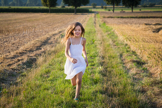 Happy little girl running in nature