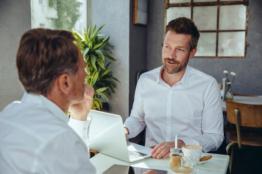 Two businessmen having a meeting in a cafe