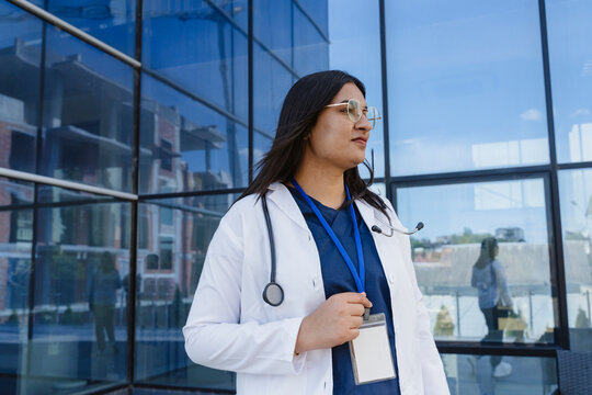 Female doctor relaxes outside the hospital during a pause