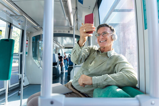 Happy male passenger taking a selfie on a tram in Barcelona Spain
