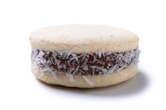 Traditional alfajores filled with dulce de leche and coconut isolated on white background