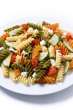 Colorful tricolor pasta salad isolated on white background