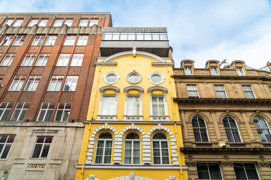 A yellow historic building stands in downtown Liverpool