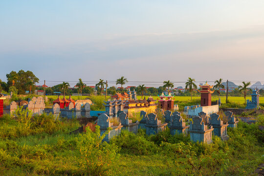 A traditional Vietnamese cemetery at sunset. Ninh Binh Province, Vietnam.