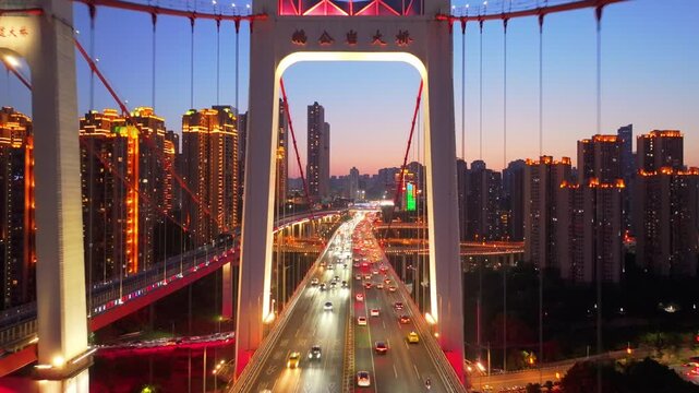 Illuminated Suspension Bridge and City Skyline at Dusk in Chongqing, China