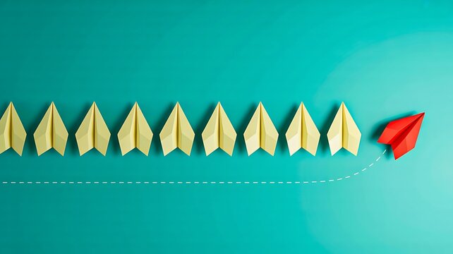Paper airplanes flying in formation with one red plane moving ahead on turquoise background