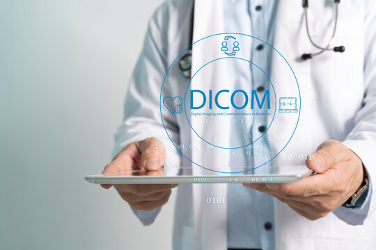 Medic in white coat holds digital tablet. Doctor holds tablet with glowing DICOM graphic.