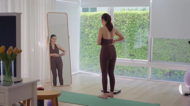 Rear view people young adult asian woman self caliper measure waist size shape lean body mass index fat track weight loss perimenopause life anti aging diet preventive modern medicine asia health care