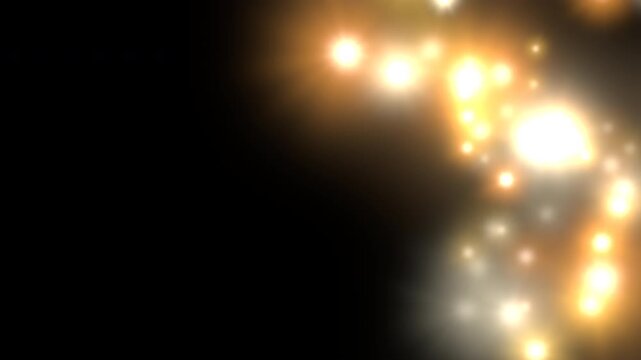 Golden light flares and sparkling bokeh particles on dark background, seamless loop animatio