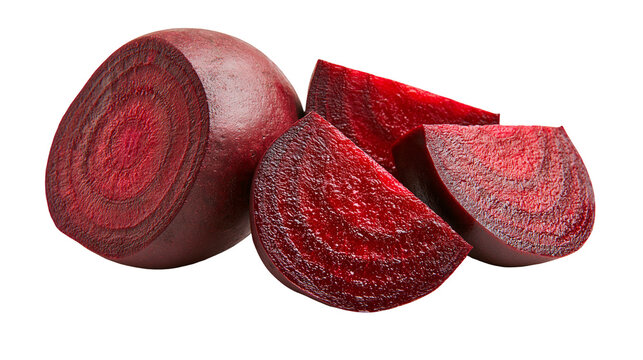 Fresh raw beetroot cut into wedges and slices with deep red flesh and skin