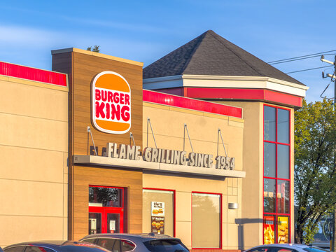 Calgary, AB, Canada. Oct 2, 2026. Exterior facade and logo signage of a Burger King restaurant building on a sunny day.
