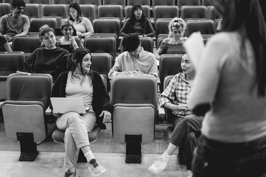 Students inside university class room - Back to school and campus lifestyle concept - Main focus on center boy head - UGC content - Black and white editing