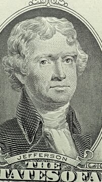 Thomas Jefferson Portrait Changes Under Green Scan. Thomas Jefferson bill moves from neutral engraving to bright green under scanning light. 