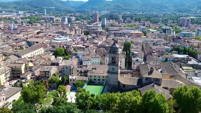 Scenic aerial drone footage of Parco della Passeggiata in Terni, Italy, capturing green trees, peaceful parkland and the calm atmosphere of an end-of-summer morning.