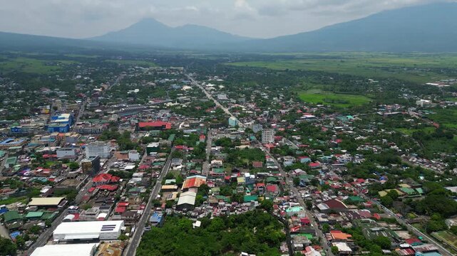 Wide aerial panorama over Tabaco City, Albay, featuring the city's urban and coastal landscape, roads, neighborhoods, port areas and Mayon Volcano rising in the background.
