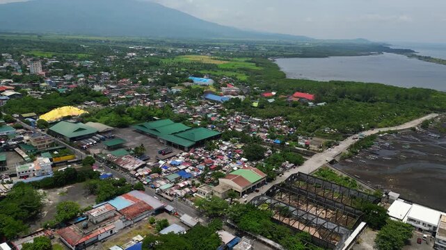 Aerial footage of Ching Bee Trading facilities and trailer trucks in Tabaco City, Albay, Philippines. The company is associated with abaca and copra trading in the Bicol Region, providing a commercial