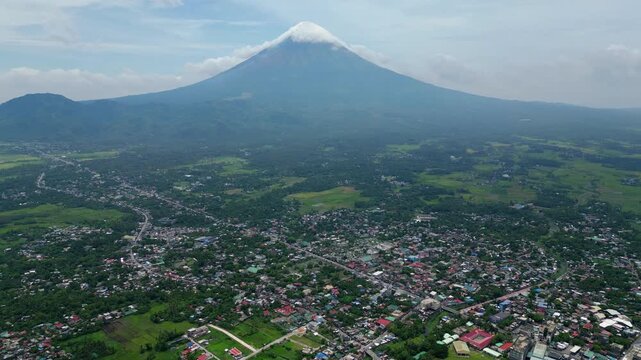 Very high altitude drone view over the San Roque and Fatima areas of Tabaco City, Albay, showing the urban landscape, roads including PNR Road and A.U. Betts Bonto Boulevard, coastal areas and Mayon V
