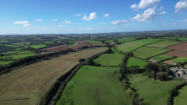 Liskeard, Cornwall, England: DRONE VIEW: The drone flies parallel to the A38 road towards a lone wind turbine on the horizon. Wind power is an integral part of the UK government's renewables strategy.