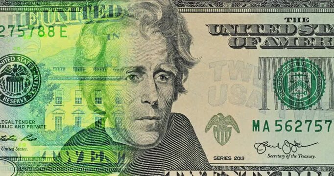 Green Light Sweeps Across Andrew Jackson Dollar Portrait. Andrew Jackson appears on twenty dollar bill as green light travels down from above. Slow sweep washes over engraved portrait.