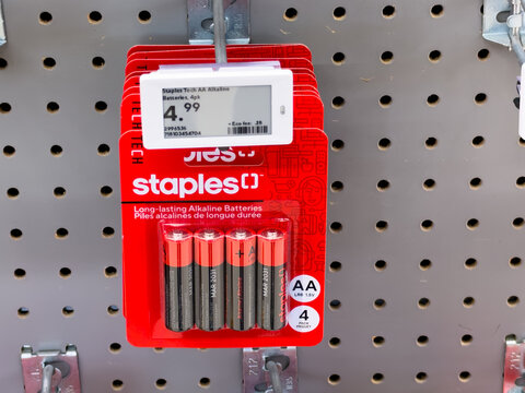 Calgary, AB, Canada. Oct 2, 2026. A pack of Staples AA alkaline batteries displayed on a pegboard hook inside a retail store.