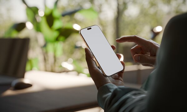 Hand Holding Smartphone with Blank Screen MockupIn an Office With Plants