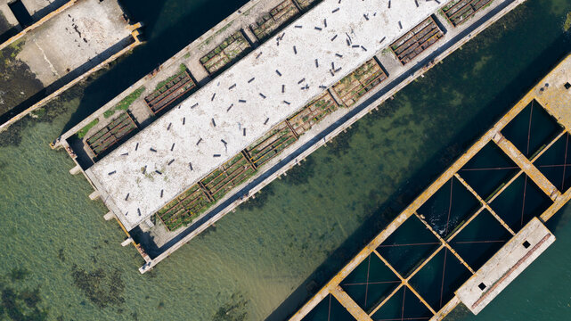 Aerial view of the historic concrete caissons at Inlaag Schelphoek, remnants of the 1953 North Sea flood defenses, in Serooskerke Schouwen, Zeeland, Netherlands.