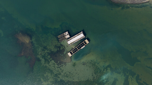 Aerial view of the historic Caissons Inlaag Schelphoek submerged in clear water, showing concrete structures resting on the sandy seabed Serooskerke Schouwen, Zeeland, Netherlands.