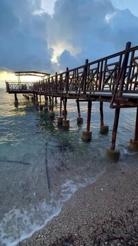 Weathered Wooden Pier Reaching into the Clear Blue Ionian Sea at Dawn