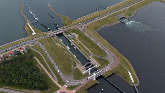 Aerial view of the Zandkreeksluis lock system with water channels, surrounding roads, and green embankments in Kortgene, Zeeland, Netherlands.
