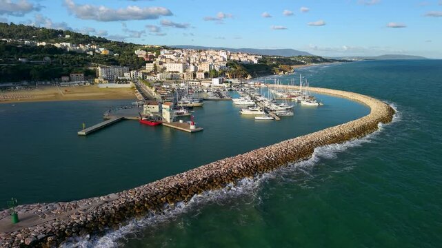 Rodi Garganico Gargano Puglia Italy idyllic coastal town drone sunrise over marina yachts empty beach faraglioni sea stacks crashing waves ambient sound. cinematic 4k footage