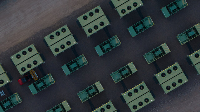 Aerial view of rows of industrial green container units arranged on a dark gravel surface in Hams Hall, England, United Kingdom.
