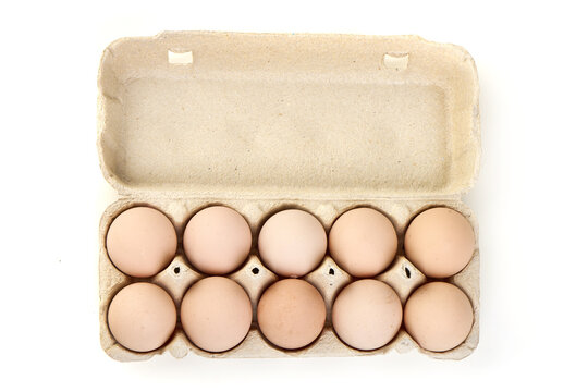 Fresh Brown Eggs in a Cardboard Carton on White Background