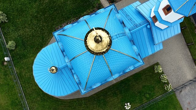 Aerial view of Russian Orthodox Church of the Nativity of the Most Holy Mother of God with bright blue roofs and golden domes surrounded by green lawns in Iecava, Bauskas novads, Latvia.