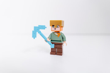 Naklejka premium Lego Minecraft Steve mini-figure holding a blue axe, shot isolated on a white backgound. Bradford, UK Oct 2 2026